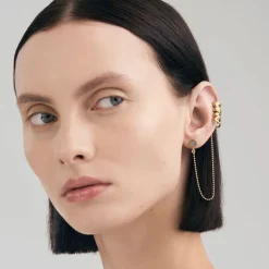 Efektowna, pozłacana nausznica z meteorytem z kolekcji Meteoros